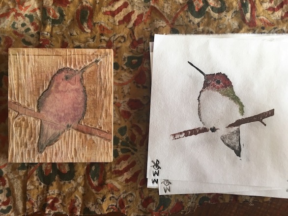 A hummingbird chiseled into a small wood block and printed