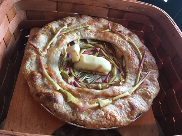A pie with an apple-carved deer resting in the center